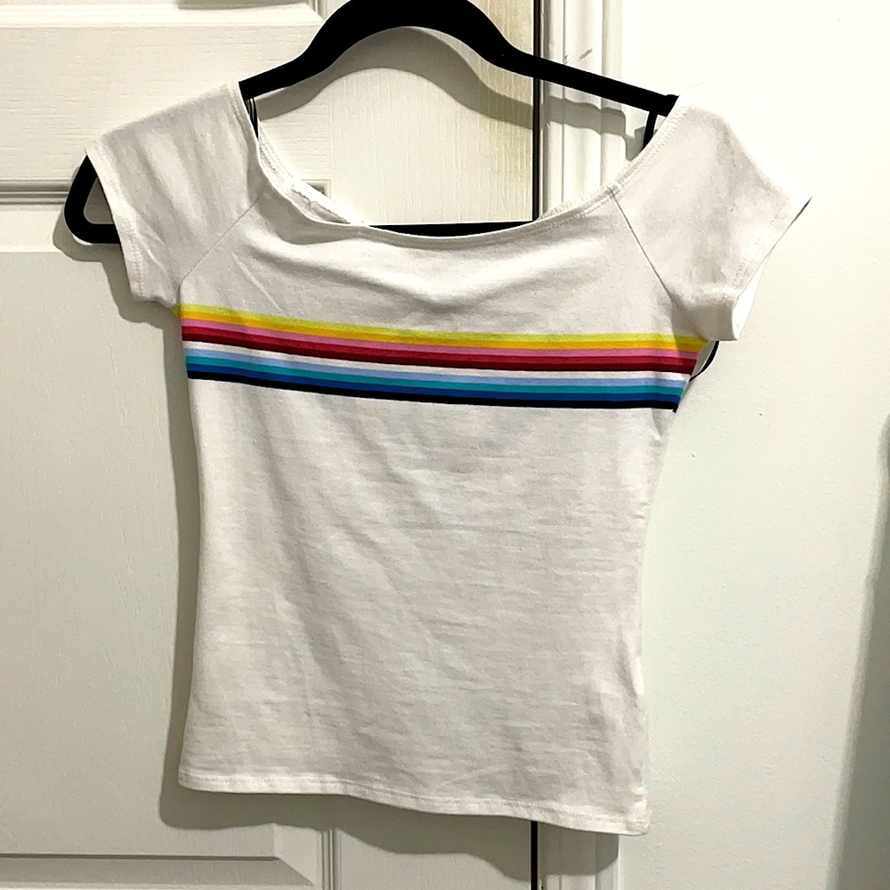 White off the shoulder tee with rainbow stripes.